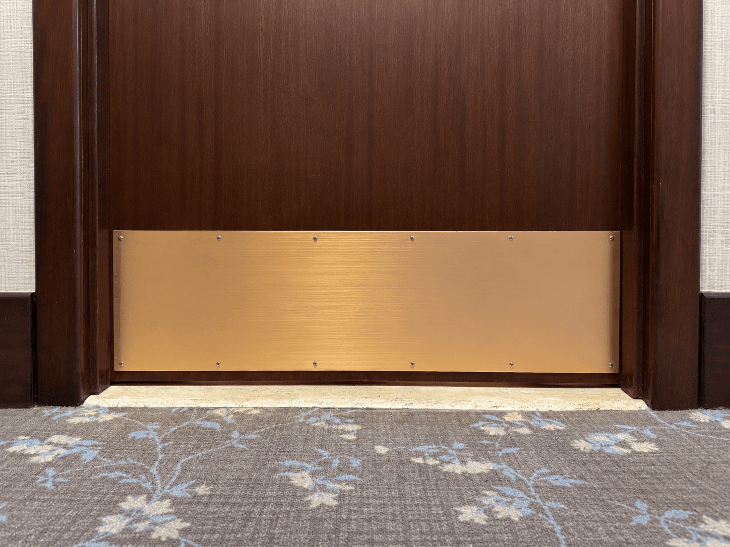 Refinished brass kick plate after refinishing